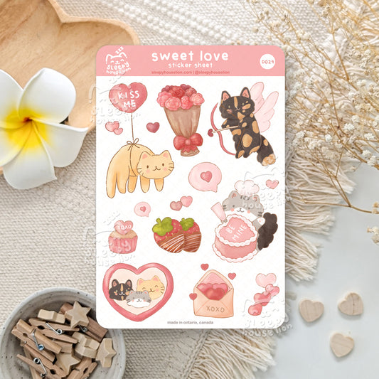 Sticker sheet with cute heart and cat illustrations on a textured surface with flowers and wooden items.