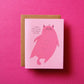 Card with a pink cat illustration and text on a pink background